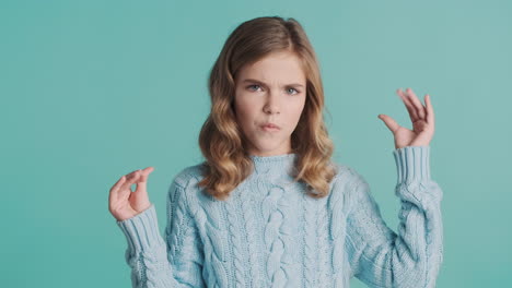 teenage caucasian girl gesturing bla bla in front of the camera.