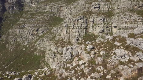 medium wide drone view of table mountain rock formation in the late afternoon sun with steep cambrian sandstone rock formations, cliffs, quartzite, and tectonic lines of the cape supergroup