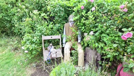 doll on chair in lush garden