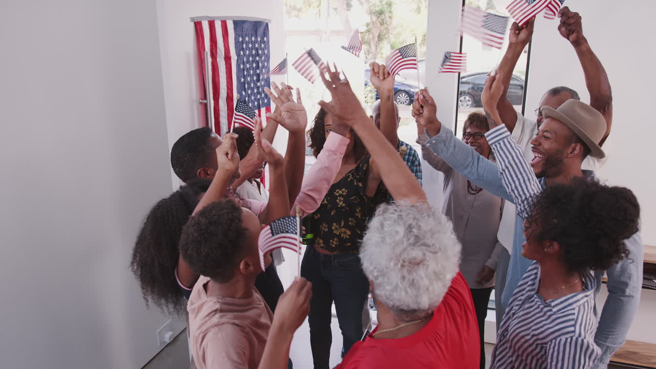 Elevated view of black family celebrating US Independence day as relatives arrive for a party