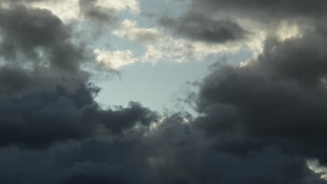 time lapse of dark clouds moving with blue patches of sky