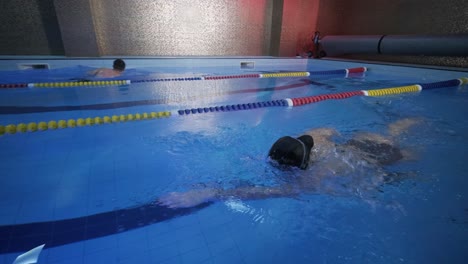 sporty young woman swimming in pool