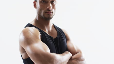 Young-biracial-athlete-man-poses-confidently-in-a-gym-setting,-with-copy-space-on-white-background