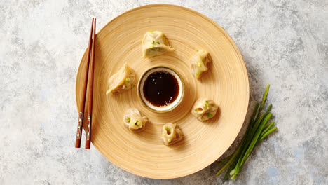 Delicious-chinese-dumplings-served-on-wooden-plate