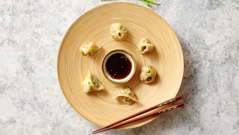 delicious chinese dumplings served on wooden plate