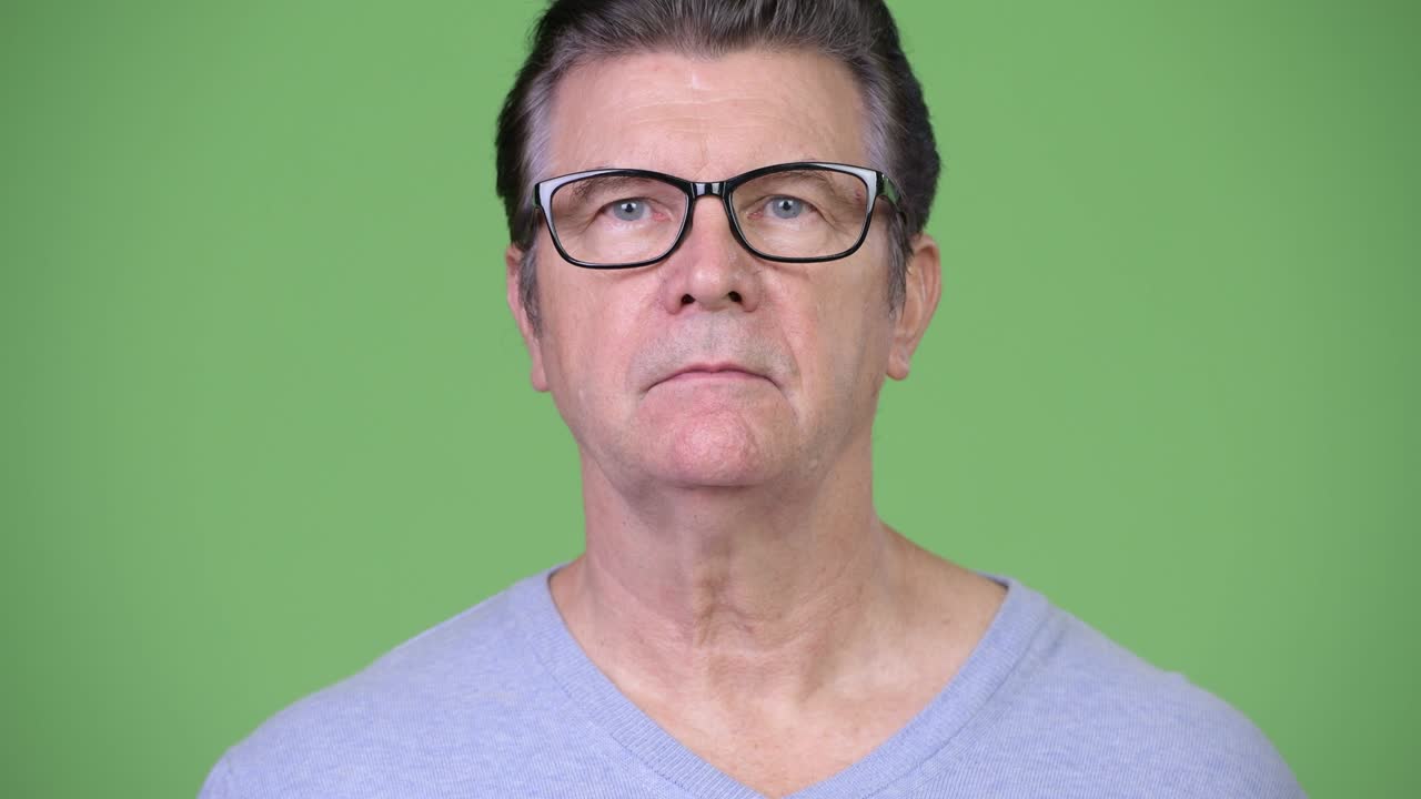 Senior handsome man looking shocked