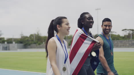 three athletes celebrating with their medals