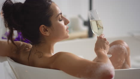 romantic woman resting in bathtub at home