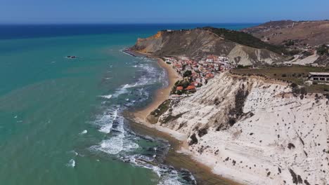 drone flies past stair of the turks to reveal typical sicilian beach