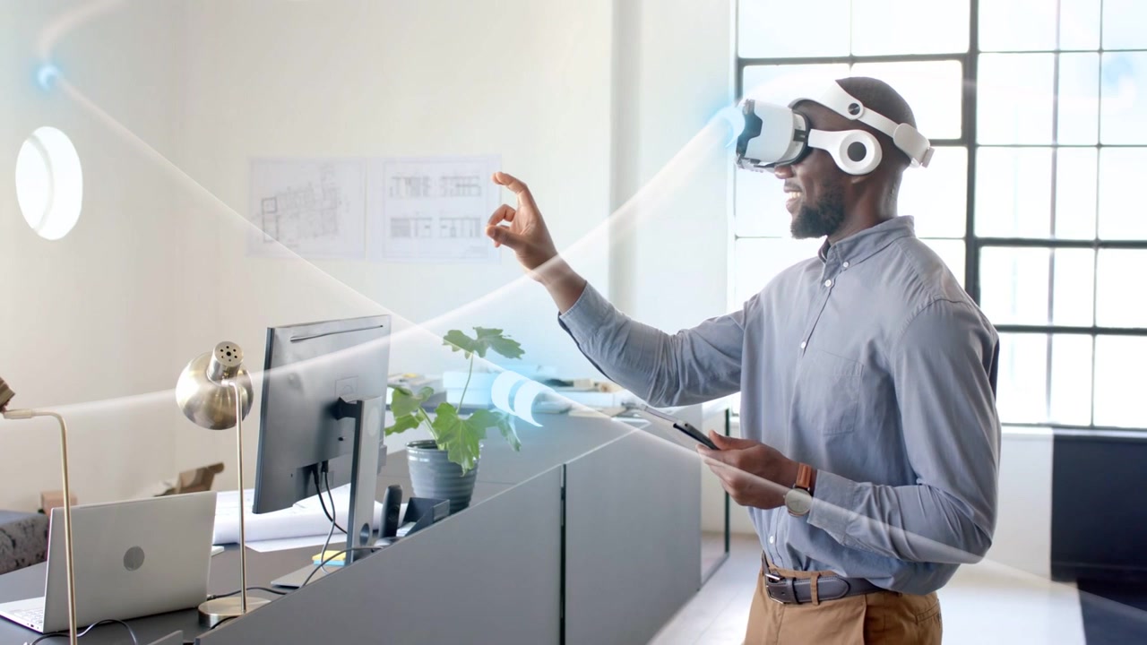 Designer touching chin then reaching forward, pinching holographic beams, refining product design