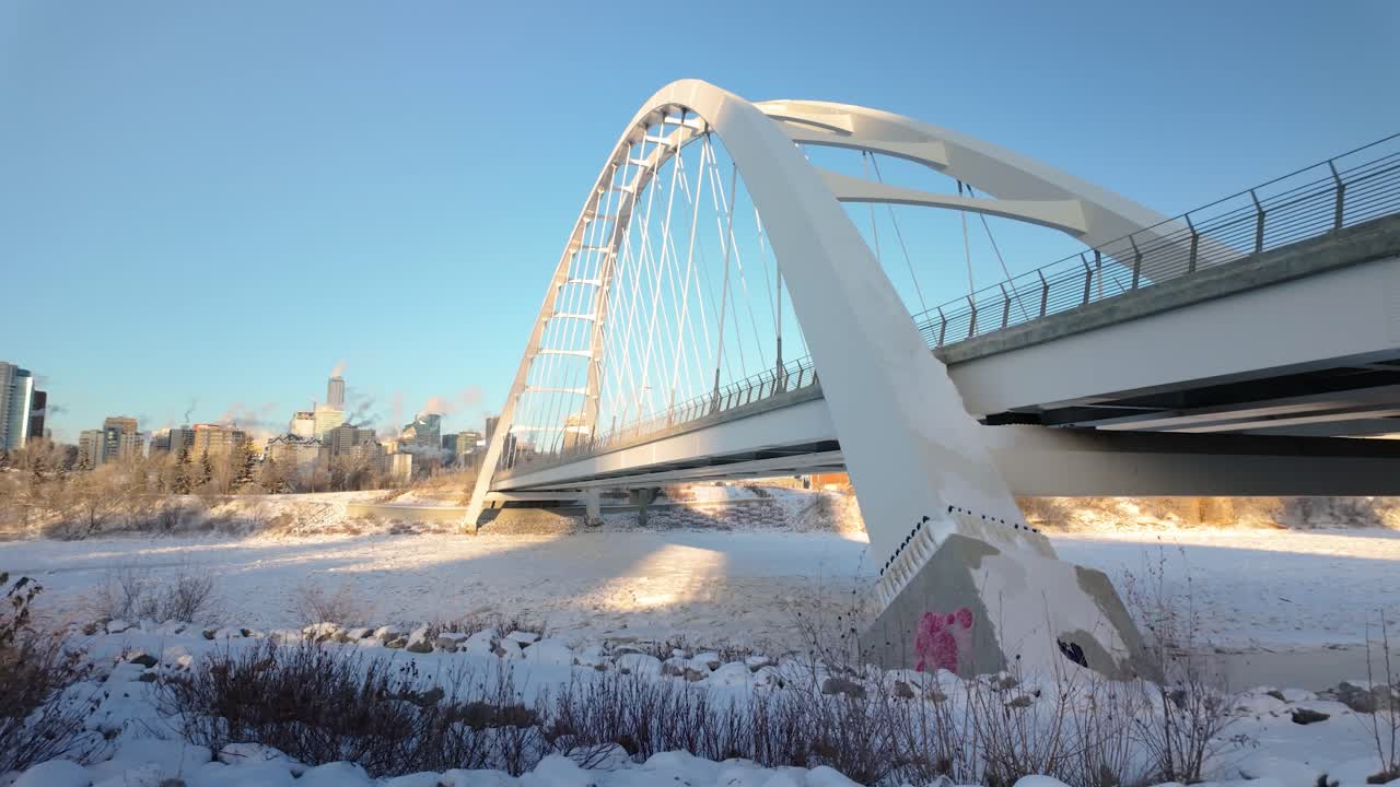 Left Side Of Walterdale Bridge, showcasing Highrise buildings Downtown Edmonton. A snowy river valley, and the cold beauty of the city