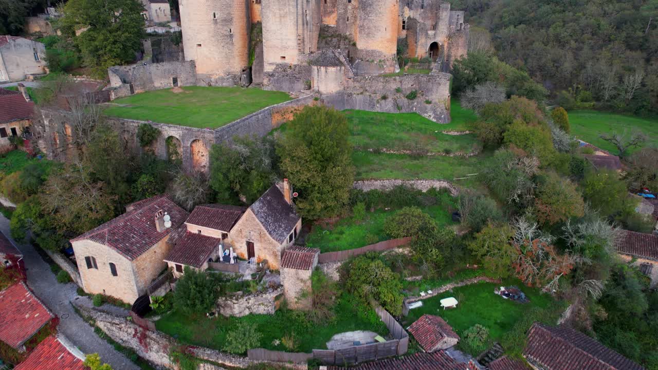 Aerial view of Bonaguil Castle overseeing its medieval village below