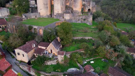 aerial view of bonaguil castle overseeing its medieval village below