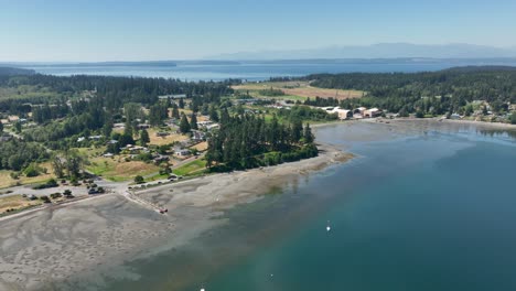 wide aerial view of freeland, wa with the olympic mountains off in the distance