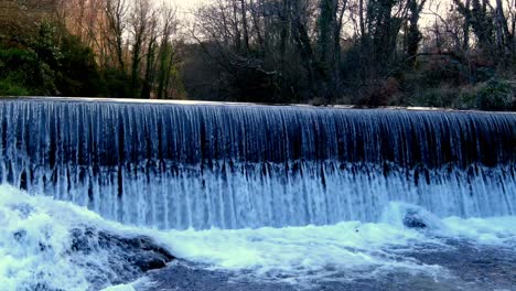 River-Flowing-Over-Small-Diversion-Dam-In-Coruna-Spain