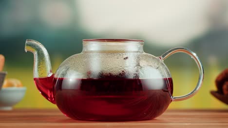 glass teapot with red tea