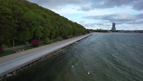 aerial view of promenade and bike path along baltic sea, into gdynia city