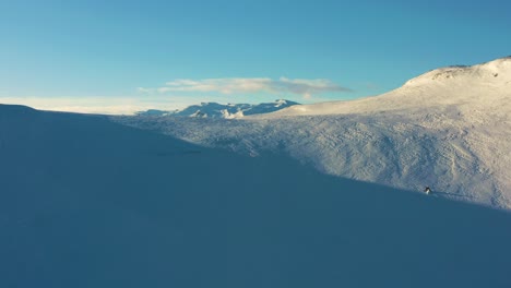 Aerial-over-the-snow-covered-valley-and-mountains-in-Hemsedal,-Norway