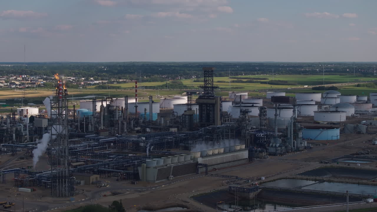 Vast oil refinery complex under blue skies, industry setting