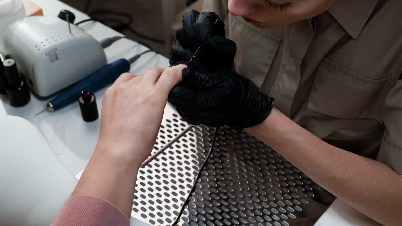 Professional Nail Technician Applying Nail Polish