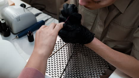 professional nail technician applying nail polish