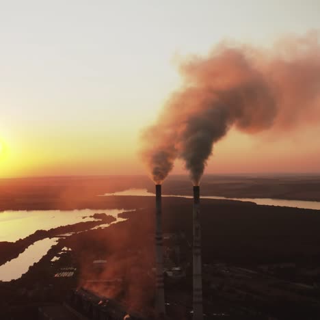 environmental problem of pollution ecology. aerial view of high chimney pipes with smoke from power plant