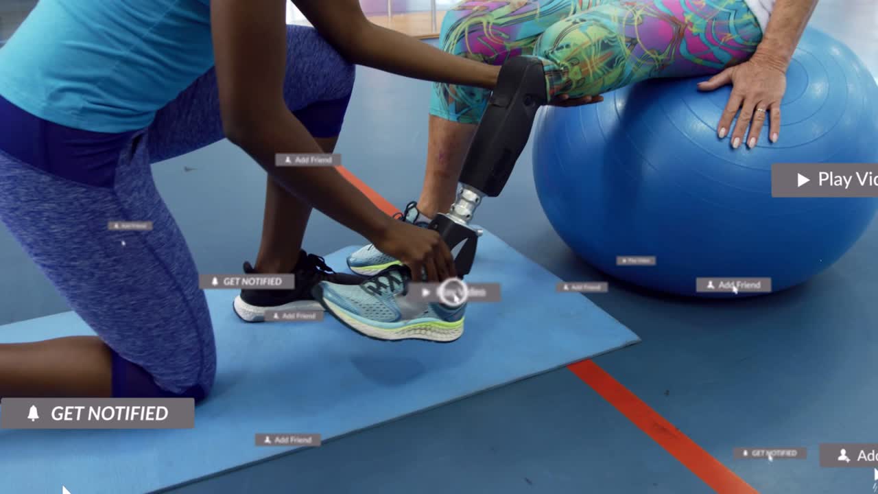 Therapist kneeling, reaching, adjusting prosthetic shoe and pylon for rehab while UI tags appearing