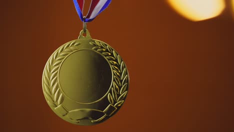 gold medal on orange background