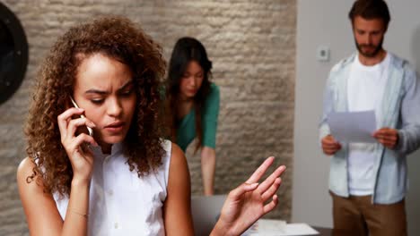 female executive talking on mobile phone