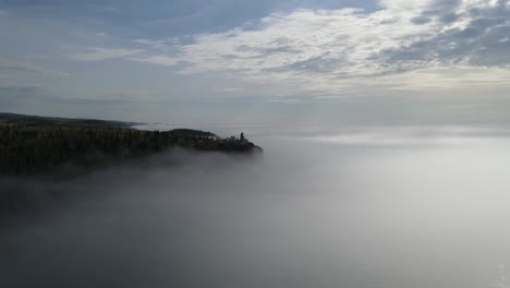 split rock light house during a foggy sunny morning, aerial footage