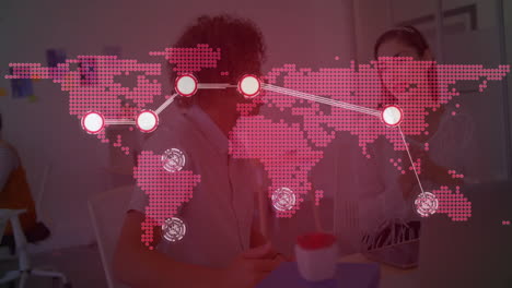 business team collaborating at office desk, analyzing global data with pink map overlay and laptop