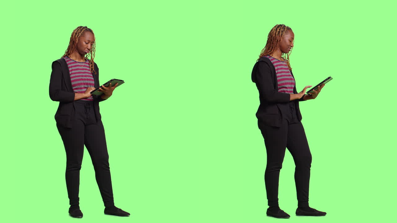 Woman using tablet in studio shot on green screen