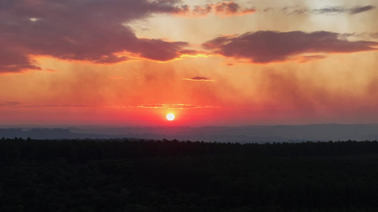 Dramatic Sunset Over Forest Landscape