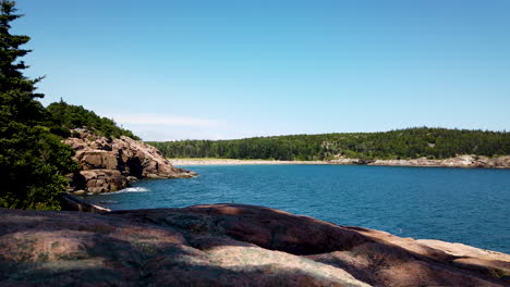 view of sand beach in acadia national park, maine, usa, static shot from large rock