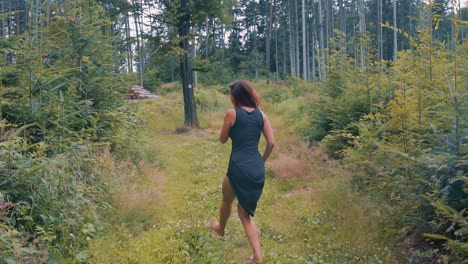 pretty woman dancing in a forest in slow motion