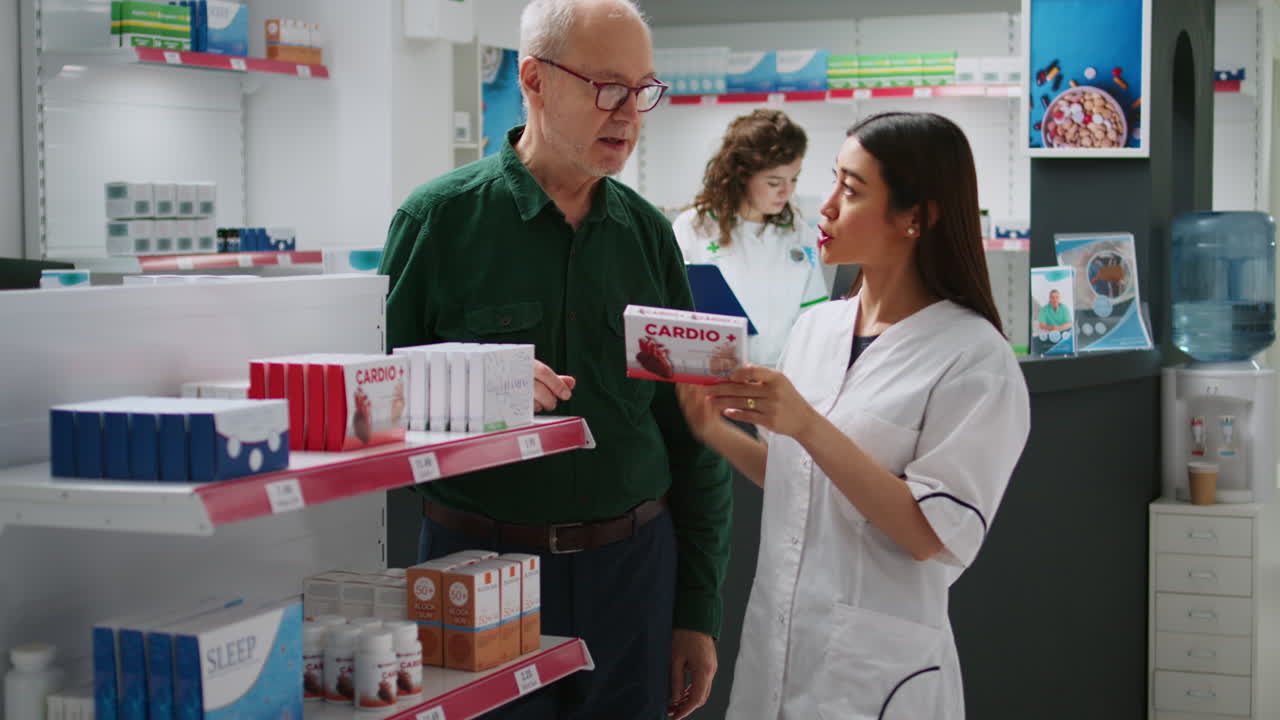 Pharmacist assisting senior customer in pharmacy