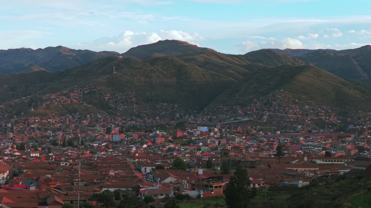 Cusco Cuzco Perú cityscape aerial drone colorful Inca neighborhood buildings main square Plaza De Armas sunset golden hour blue skies clouds Vive en el Peru mountain hillside high altitude upwards
