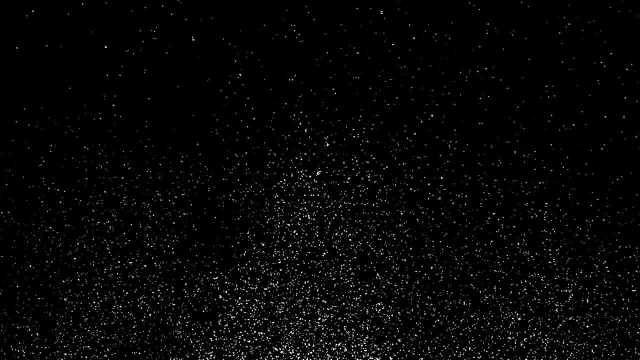 nieve blanca que cae rápidamente o pequeñas escamas abstractas sobre un fondo negro.