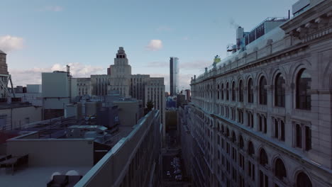 Fly-high-above-street-around-multistorey-building-roof.-Revealing-large-building-of-Manhattan-Criminal-Courthouse.-Manhattan,-New-York-City,-USA