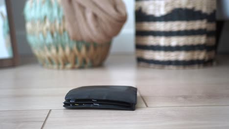 black leather wallet on wooden floor