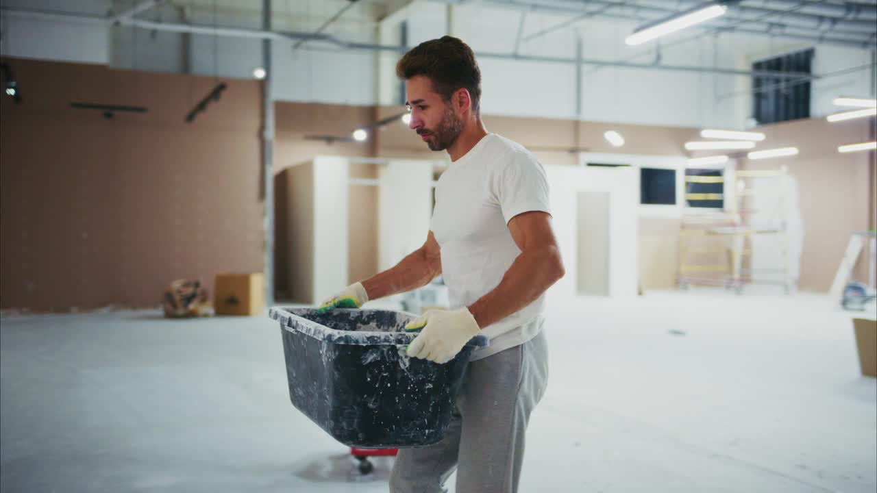 A Dedicated Worker Engages in Construction Tasks, Mixing Materials and Ensuring Quality as He Prepares Workspace for Successful Renovation Project