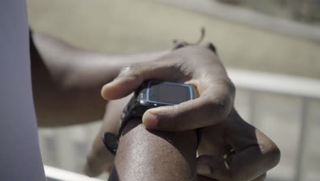 Closeup-shot-of-sportsman-setting-sport-watch-before-training