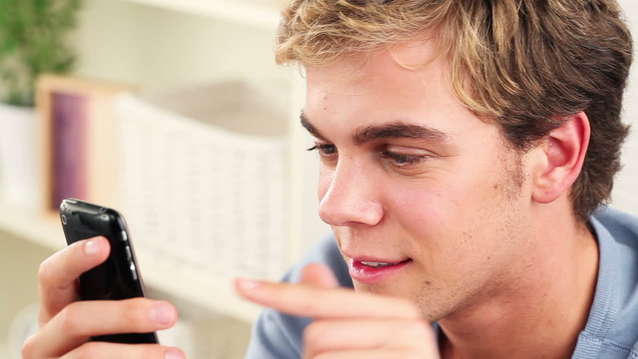 Close up of young man using mobile phone