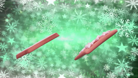 animación de galletas de pan de jengibre de navidad sobre copos de nieve que caen sobre un fondo verde.