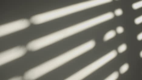 shadow on the wall of a closing window shutter