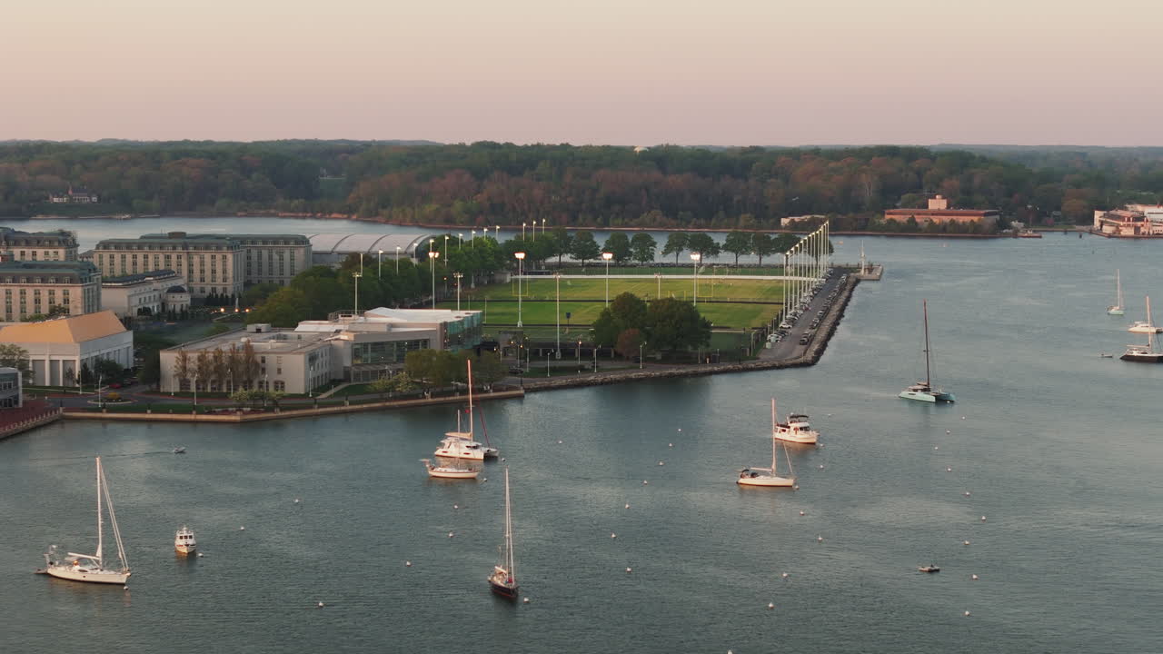 Boats In The Spa Creek With Rip Miller Field During Sunset In Annapolis, Maryland, USA. - aerial shot