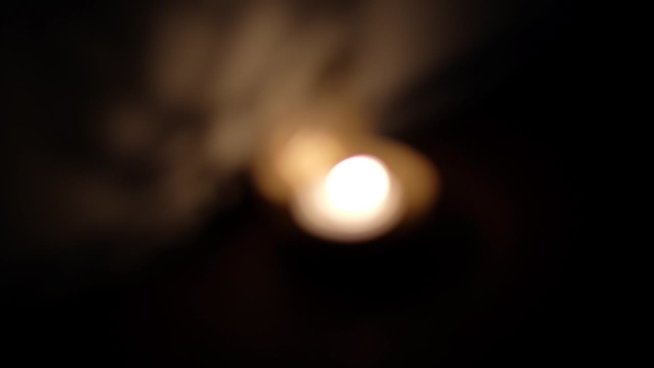 Defocus bokeh shadow and light dance, play reflection on wall of Ganesha cutout, also Ganapati Vinayaka, one of the best-known and most worshipped deities in the Hindu pantheon, during Diwali