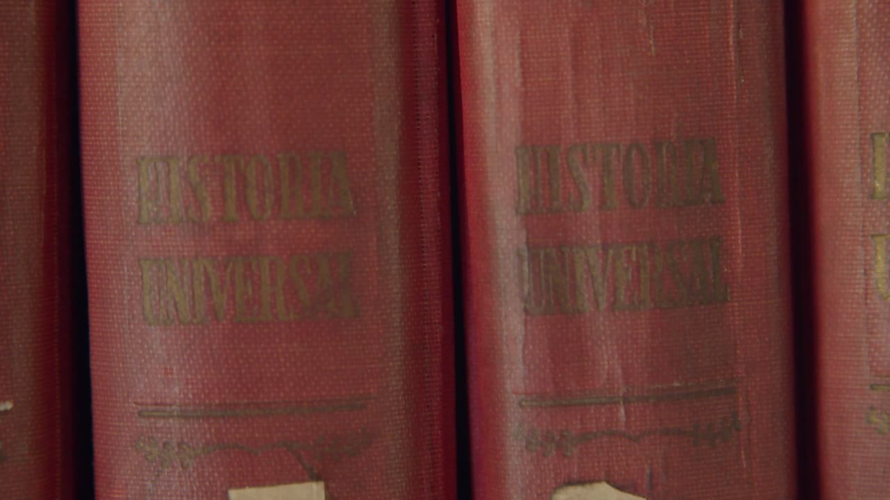 Closeup shoot of an old home library - Warm and dusty house vibes - Old books in spanish - 4k at 60fps (slowmotion)