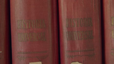 closeup shoot of an old home library - warm and dusty house vibes - old books in spanish - 4k at 60fps (slowmotion)
