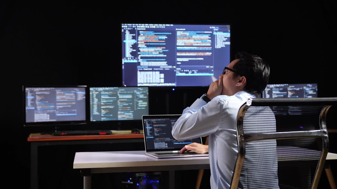 programador trabajando en un entorno de oficina oscuro.